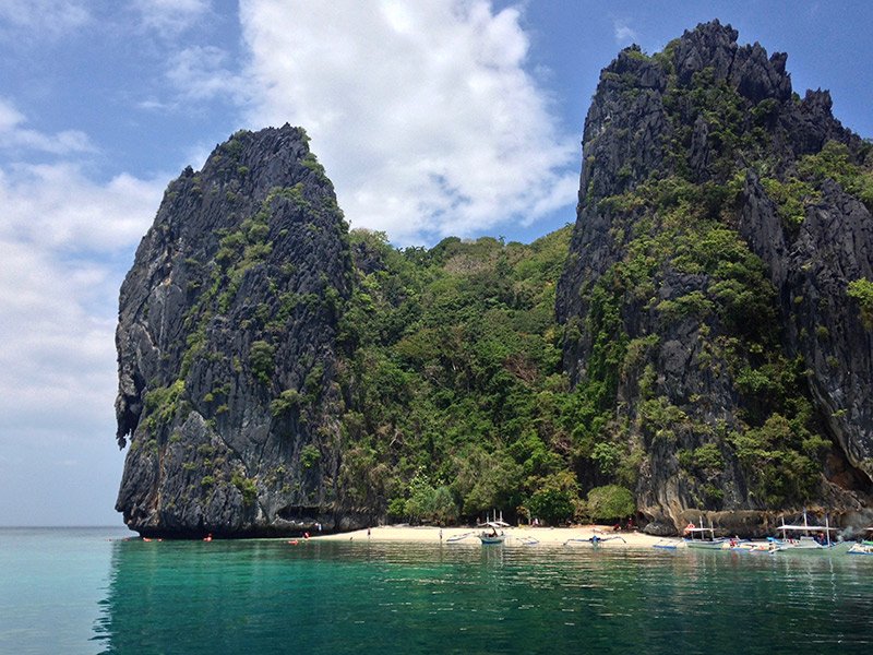 Sit back and relax while island hopping through the crystal-clear waters around Palawan